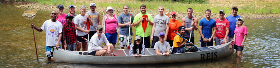 Group of Biology Students Conducting Research in Riverbed
