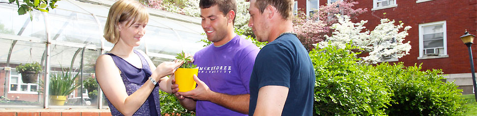 Photo of Dr. Schutzenhoffer and Students in front of Greenhouse