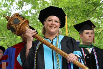 Female Graduate Student Holding Academic Mace