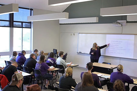 Profesor in Classroom Full of Students