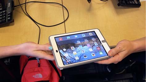 Students Passing an iPad