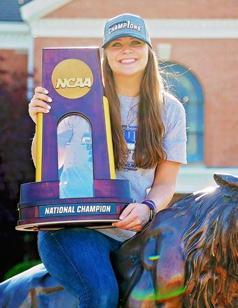Photo of Jessica Mellott ‘18 holding NCAA Champion Trophy