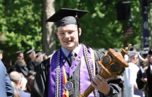 Student carrying mace at commencement