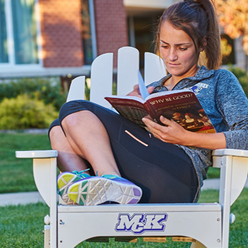 Female Student Reading a Book Outside Female Student Reading a Book Outside