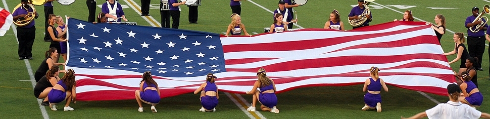 Photo of American Flag on Leemon Field held by the McK Dance Team and the PomCats