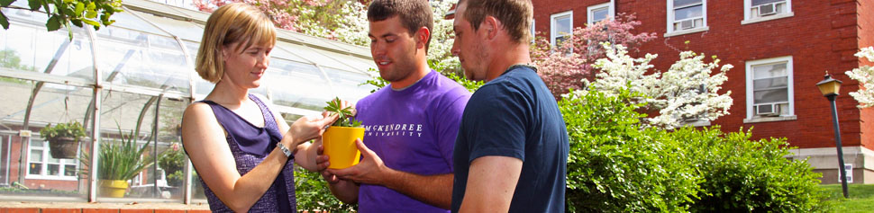 Photo of Dr. Schutzenhofer and Students in front of Greenhouse